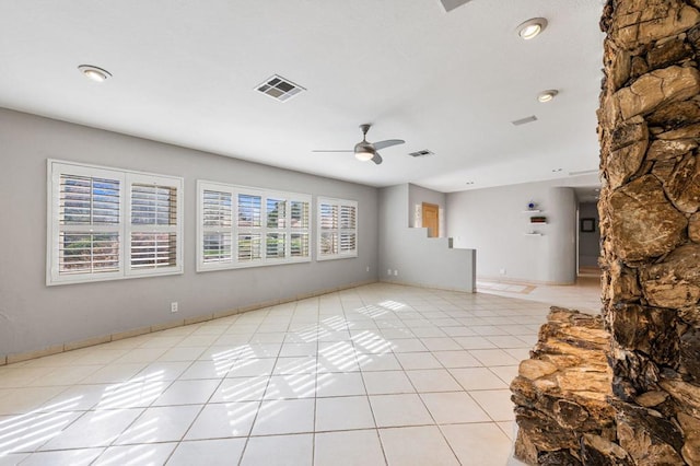 unfurnished living room featuring ceiling fan and light tile patterned flooring