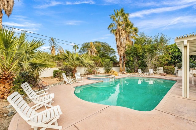 view of swimming pool featuring an in ground hot tub and a patio