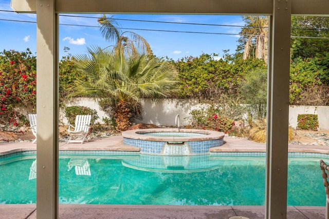 view of swimming pool featuring an in ground hot tub