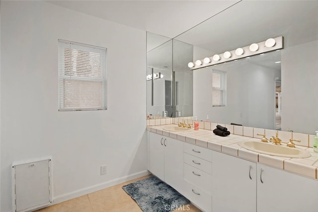 bathroom with tile patterned floors, vanity, and plenty of natural light