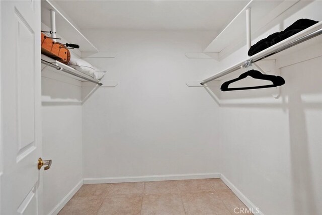 spacious closet with light tile patterned flooring