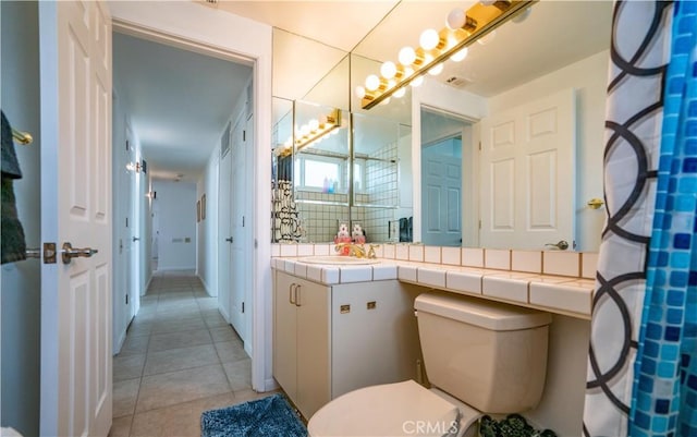 full bathroom featuring toilet, tasteful backsplash, vanity, and tile patterned floors