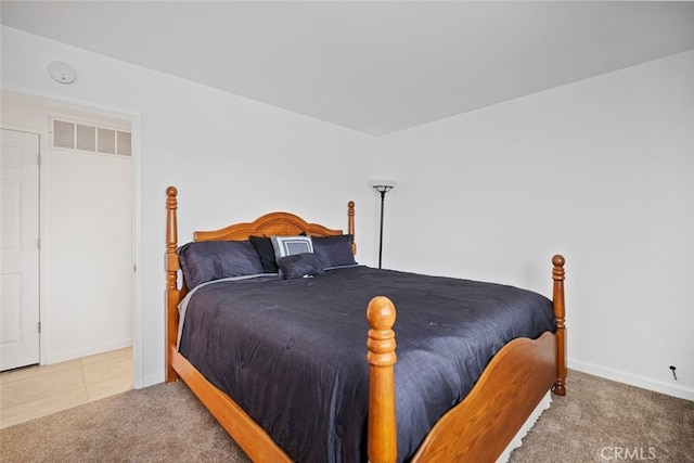 carpeted bedroom featuring visible vents and baseboards