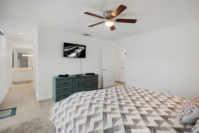 bedroom featuring a ceiling fan, visible vents, light carpet, and baseboards