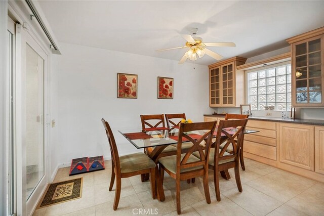 dining area with ceiling fan and light tile patterned floors