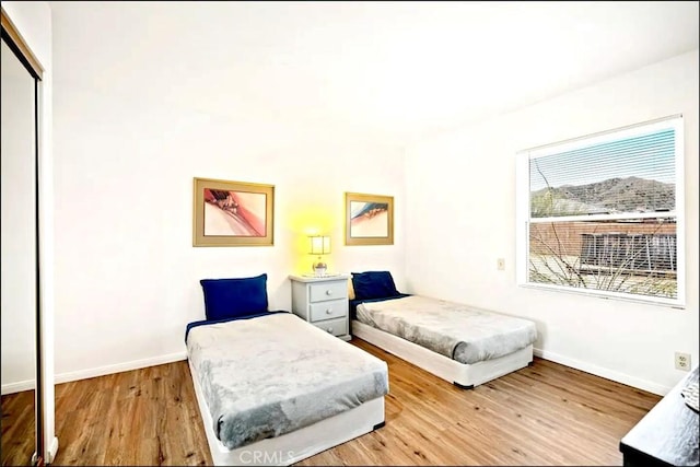 bedroom featuring a closet and light wood-type flooring