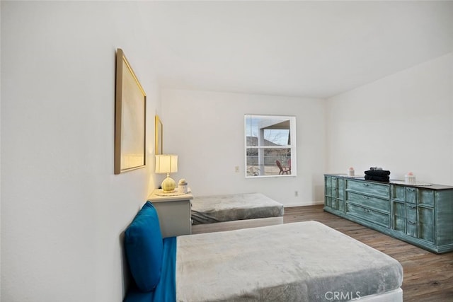 bedroom with dark wood-type flooring