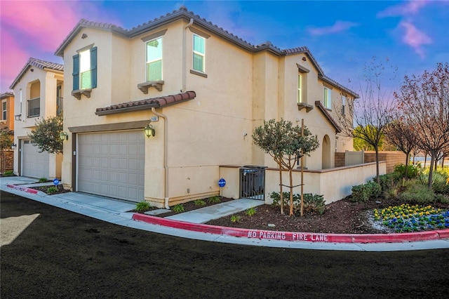 property exterior at dusk with a garage