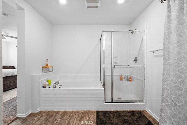 bathroom with hardwood / wood-style flooring and plus walk in shower