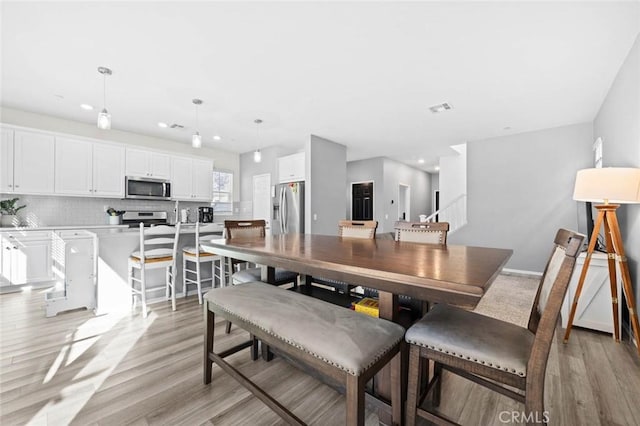 dining space featuring light hardwood / wood-style flooring