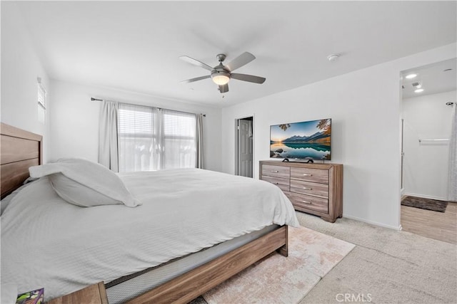 bedroom with ceiling fan and light carpet