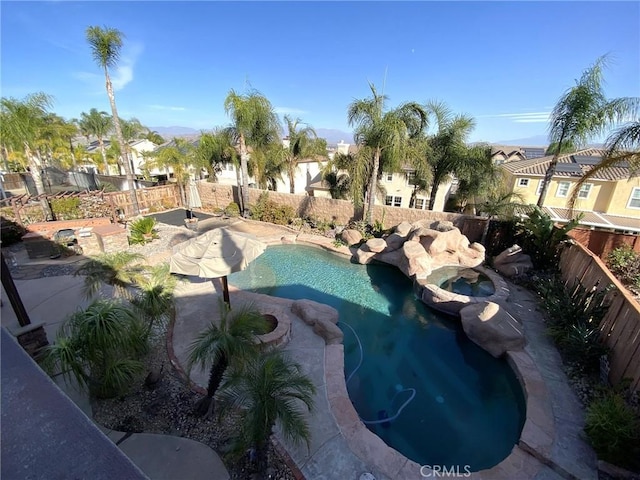 view of pool with an in ground hot tub and a patio