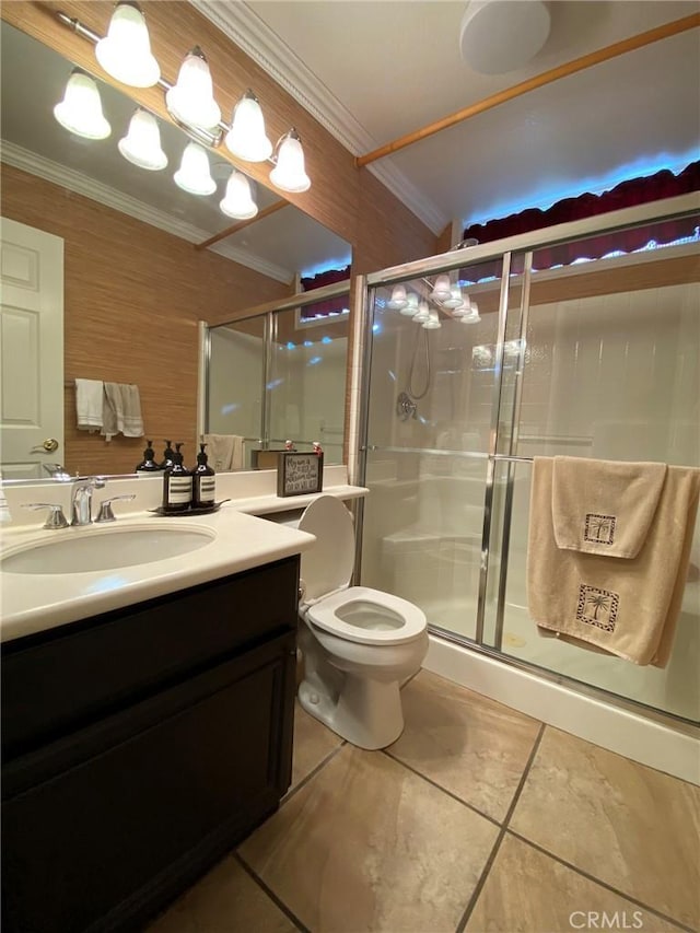 bathroom featuring toilet, tile patterned flooring, walk in shower, and vanity