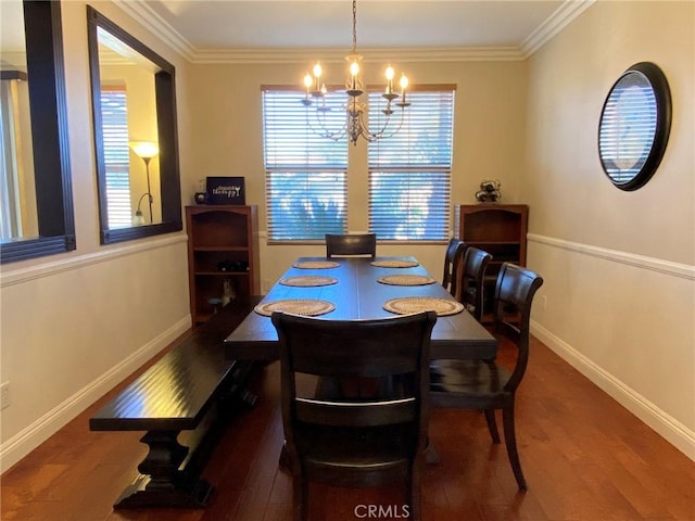 dining room featuring dark hardwood / wood-style flooring, crown molding, and a chandelier