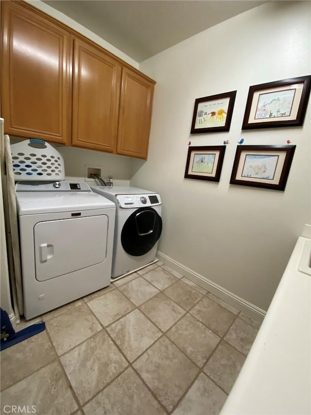 laundry area with cabinets and separate washer and dryer