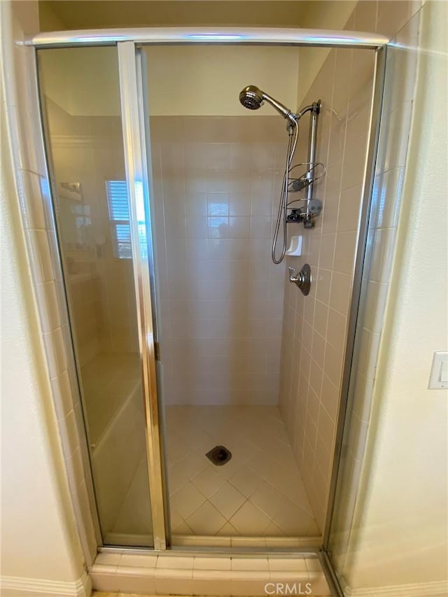 bathroom with a shower with shower door