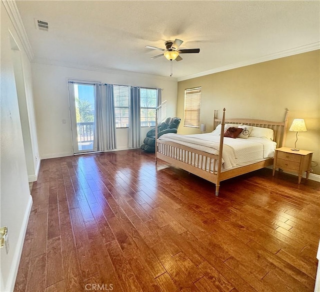 bedroom with a textured ceiling, dark hardwood / wood-style flooring, access to outside, ornamental molding, and ceiling fan