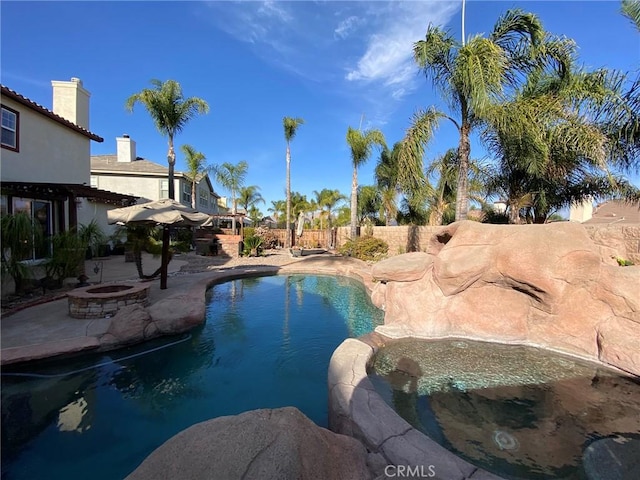 view of pool featuring an outdoor fire pit and a patio area