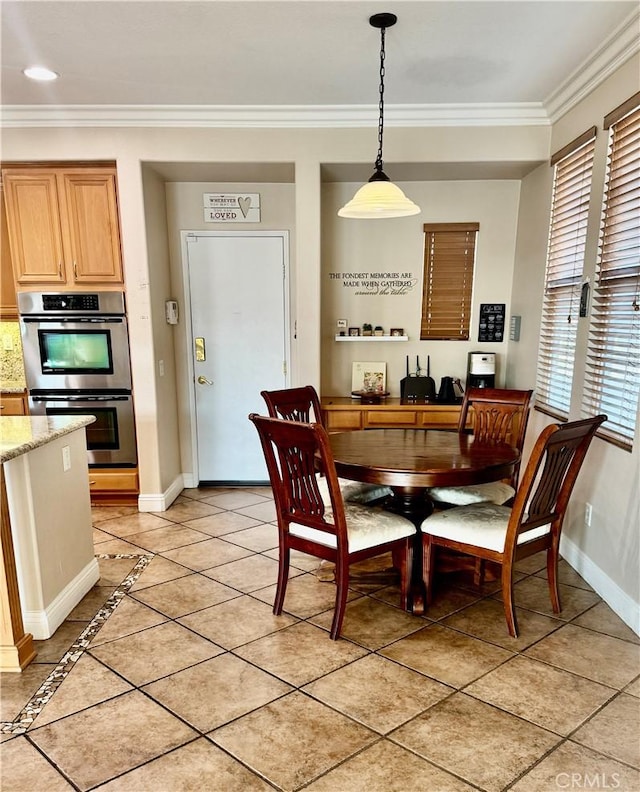 dining space with ornamental molding and light tile patterned flooring