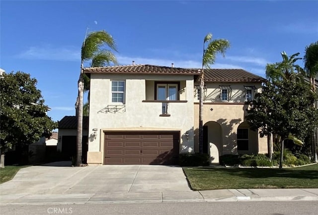 mediterranean / spanish-style house with a garage