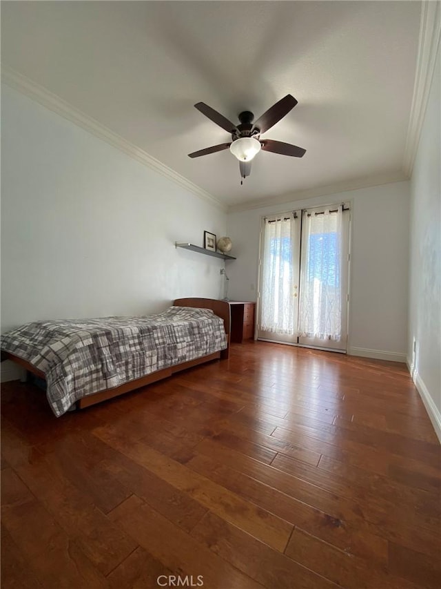 unfurnished bedroom with ceiling fan, dark hardwood / wood-style flooring, and ornamental molding