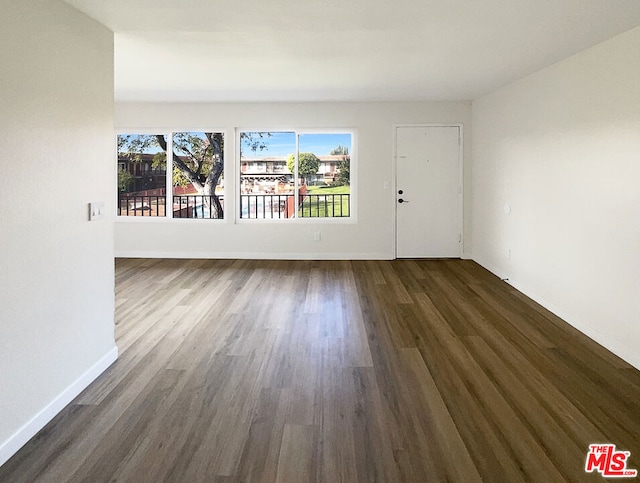 spare room with dark hardwood / wood-style flooring