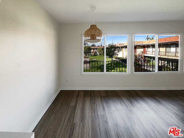 unfurnished room with dark wood-type flooring