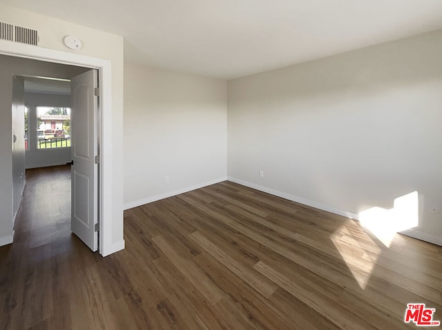 spare room featuring dark hardwood / wood-style floors