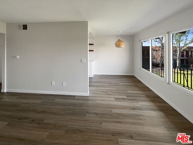 spare room featuring dark wood-type flooring