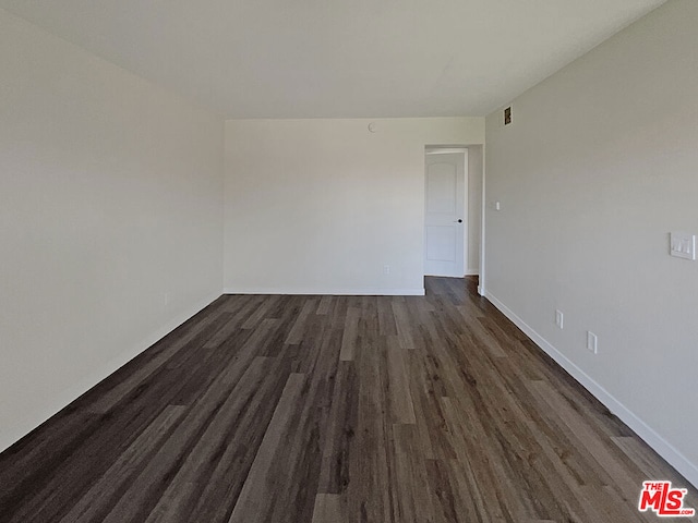 spare room featuring dark hardwood / wood-style flooring