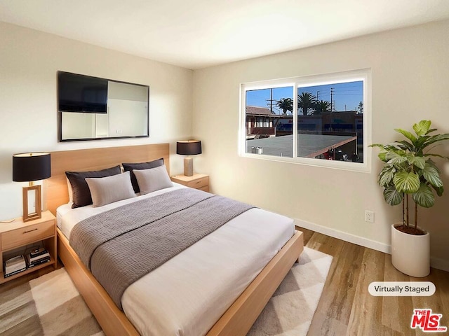 bedroom with hardwood / wood-style floors