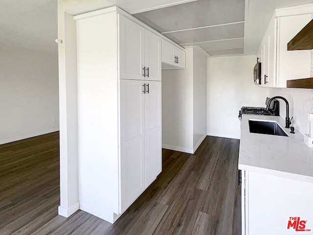 kitchen with sink, white cabinetry, range hood, and dark hardwood / wood-style flooring