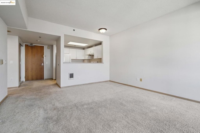 unfurnished living room with light carpet