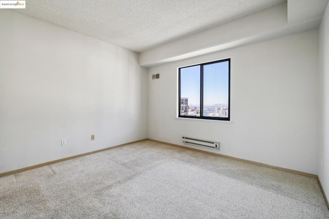 carpeted spare room with a textured ceiling