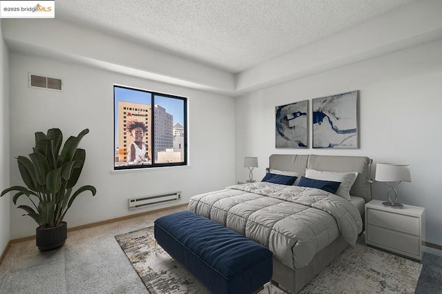 bedroom featuring a baseboard radiator and a textured ceiling