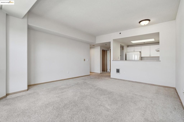 unfurnished living room with light colored carpet