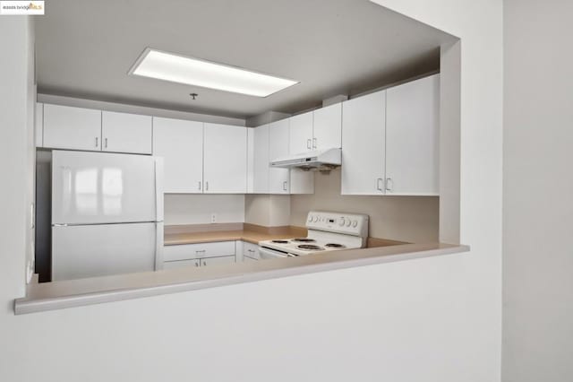 kitchen featuring white appliances and white cabinets