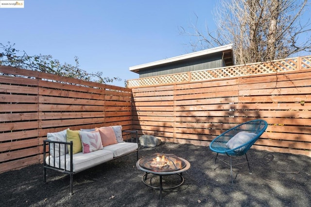 view of patio / terrace featuring an outdoor living space with a fire pit