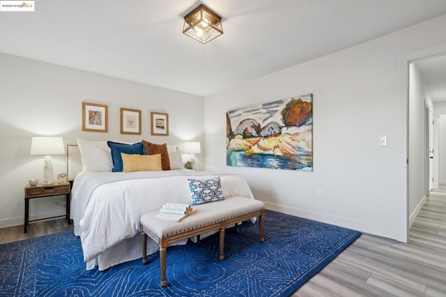 bedroom with hardwood / wood-style flooring