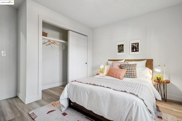 bedroom with a closet and light hardwood / wood-style flooring