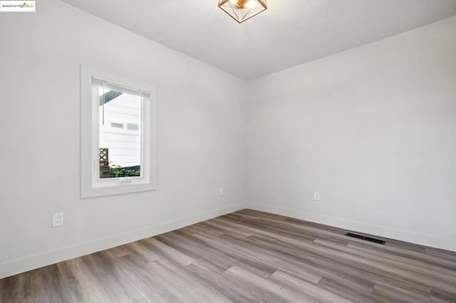 spare room with light wood-type flooring