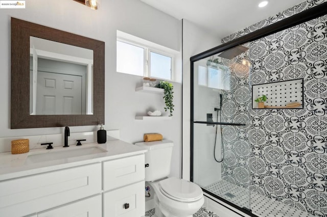 bathroom with vanity, walk in shower, and toilet