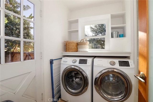 clothes washing area featuring washer and clothes dryer