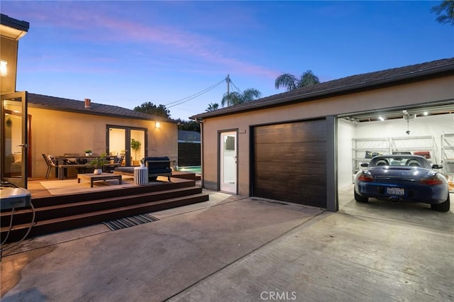 view of garage at dusk