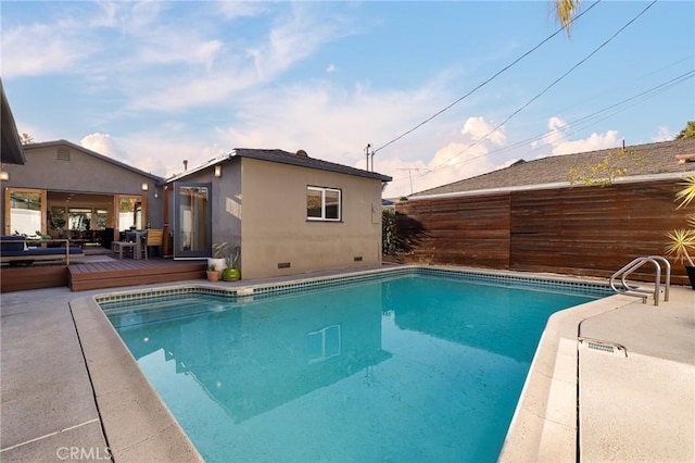 view of swimming pool with a wooden deck