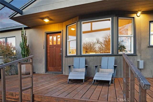 exterior entry at dusk with a wooden deck