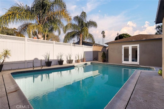 view of swimming pool with french doors