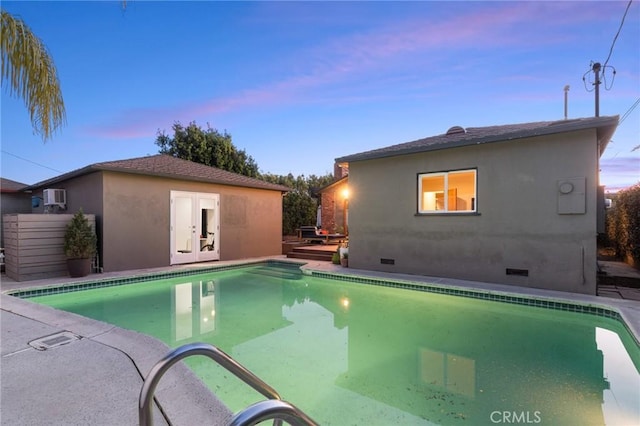 pool at dusk with a wall mounted AC