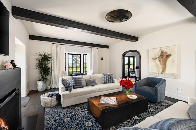 living room with dark hardwood / wood-style floors and beamed ceiling