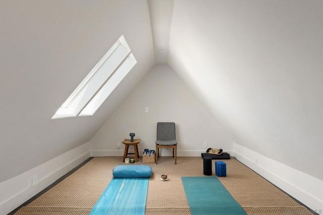 workout area with carpet floors and vaulted ceiling